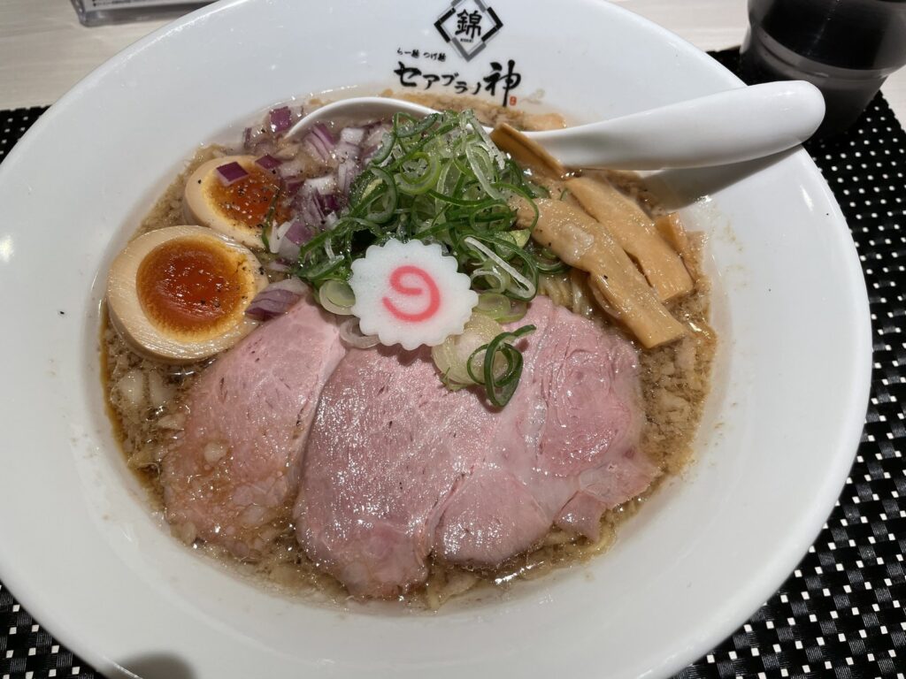 A bowl of Japanese ramen with chashu pork, egg, menma and green onions