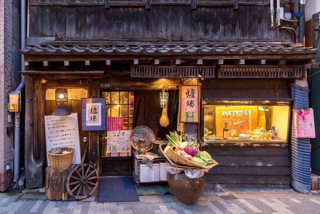 How Japanese Writing Works: Kanji, Hiragana and Katakana Illuminated facade of a restaurant serving traditional food with fresh vegetables in Chiyoda, Tokyo